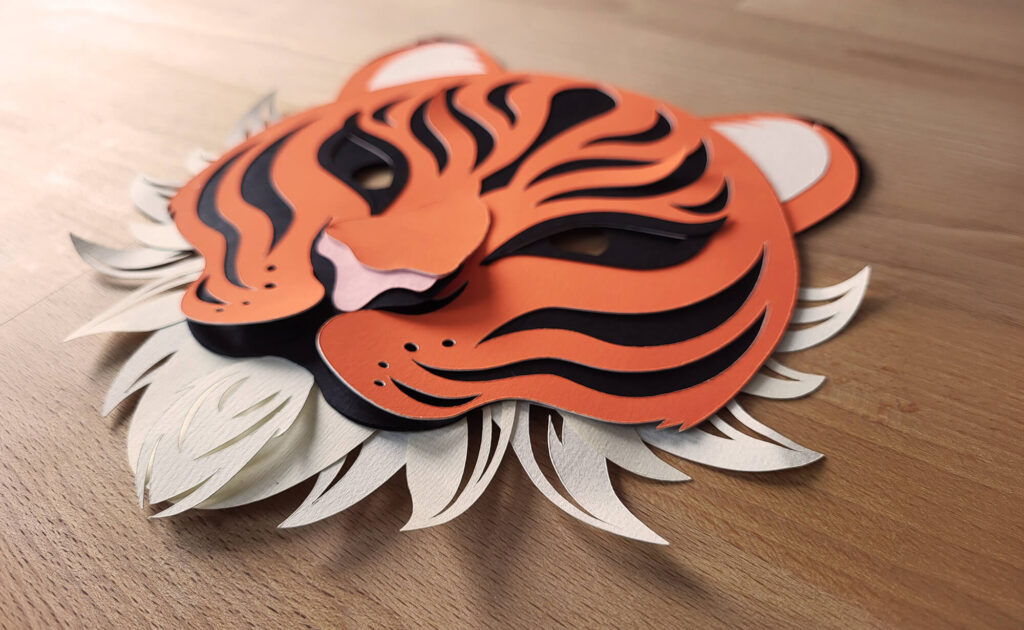 Référence d'Ylos : création d'un masque de tigre en papier découpé pour le carnaval